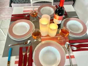 a table with plates and wine glasses and wine bottles at Chora Suite in Mikonos +22 photos