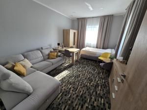 a living room with a couch and a bed at Welle DOLCE VITA in Grzybowo