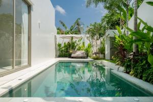 an image of a swimming pool in a house at Coco Villas Phuket - Private Pool Villas by Escape Villas in Thalang