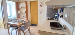 a small kitchen with a small table and a sink at Mike's Residence at Marina Spatial - Dumaguete City in Piapi