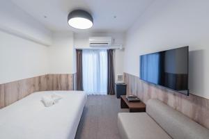 Telewizja i/lub zestaw kina domowego w obiekcie Apartment Hotel 11 Nagoya