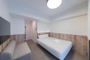 Łóżko lub łóżka w pokoju w obiekcie Apartment Hotel 11 Nagoya