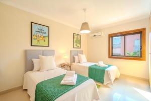 a room with two beds and a window at Entre o Vale e o Mar - Vale Parra in Guia +18 photos