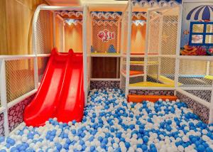a play room with a red slide and a bunch of balls at Hôtel de l'Amour Tam Đảo in Tam Ðảo +51 photos