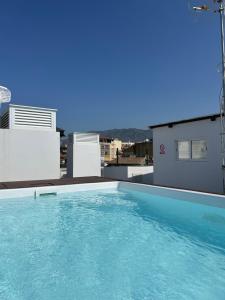 a swimming pool on the roof of a building at A top-floor modern apartment Located 100 meters from the beach in Fuengirola