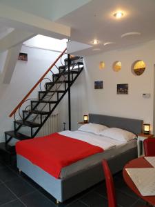 a bedroom with a bed and a spiral staircase at CASA ARYAN in Sînpetru