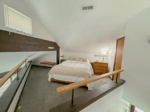 a attic bedroom with a bed and a staircase at Treehouse Treetop Village101-3bed3bapools-8pp in Four Seasons +41 photos