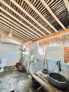 a bathroom with a sink and a toilet at Palm Green Hotel in Kuta Lombok