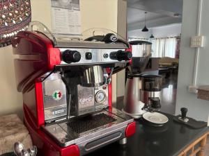 a red coffee maker sitting on a counter at Auroma Guest house in Katmandu International