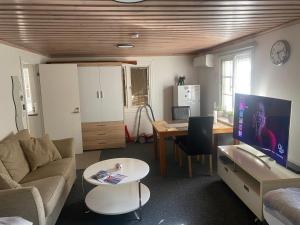 a living room with a couch and a table and a desk at Karlskrona in Rödeby