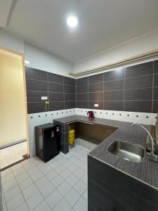 a large kitchen with a sink and a counter at Golden Straits Villas Beach Resort - Nomad Homestay in Port Dickson