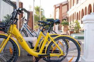 two yellow bikes parked next to each other on a street at Hotel Boutique Calas de Alicante in Alicante