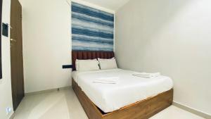 Postel nebo postele na pokoji v ubytování Palm Breeze Hotel - Colaba