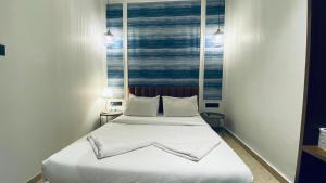 Postel nebo postele na pokoji v ubytování Palm Breeze Hotel - Colaba