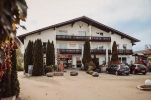 a large building with cars parked in front of it at Hotel & Gasthof Wagner in Aichach