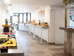 a kitchen with a long counter with food on it at Hotel Boutique Calas de Alicante in Alicante
