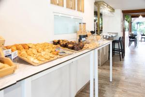 a bakery with a bunch of different types of bread at Hotel Boutique Calas de Alicante in Alicante