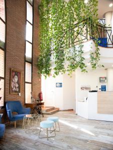 a room with plants hanging from the ceiling at Hotel Boutique Calas de Alicante in Alicante