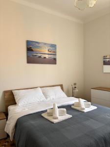 a bedroom with a bed with two towels on it at Trilocale a 100 m dal mare in Imperia
