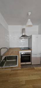 cocina con fregadero de acero inoxidable y nevera en Edén Los Cristianos, en Los Cristianos