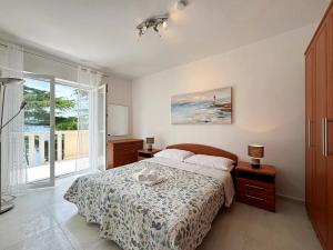 a bedroom with a bed and a large window at Apartments Scheich in Šilo +129 photos