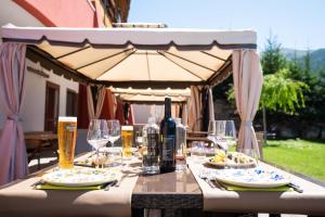 a table with a bottle of wine and glasses at Hotel La Chance in Pila