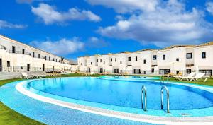 a large swimming pool in front of a building at Checkin Ocean Tenerife in San Miguel de Abona
