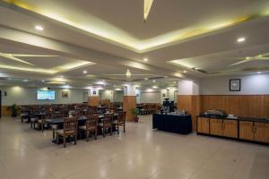 a large banquet hall with tables and chairs at Excel Hotels & Resorts Bhimtal in Bhīm Tāl
