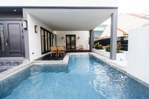 a swimming pool in the backyard of a house at Sun Sky Pool Villa 5 Bed Group Friendly BBQ KTV in Pattaya South