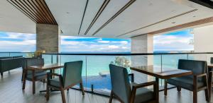 a dining room with a view of the ocean at Boton Blue Hotel & Spa in Nha Trang