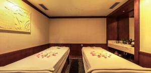a room with two beds in a room at Boton Blue Hotel & Spa in Nha Trang