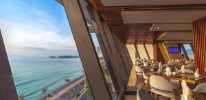 a restaurant with a view of the ocean at Boton Blue Hotel & Spa in Nha Trang