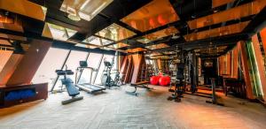 a gym with treadmills and elliptical machines at Boton Blue Hotel & Spa in Nha Trang