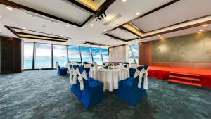 a conference room with tables and chairs and a screen at Boton Blue Hotel & Spa in Nha Trang +37 photos
