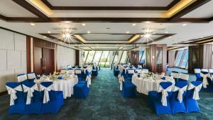 a banquet hall with blue and white tables and chairs at Boton Blue Hotel & Spa in Nha Trang