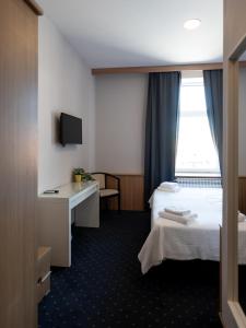Postel nebo postele na pokoji v ubytování Hotel Admiral Vinkovci