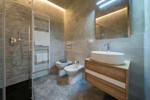a bathroom with a sink and a toilet and a shower at La Casa del Bersagliere - STUDIO in Biella +5 photos
