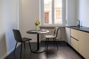 a small kitchen with a table and two chairs at La Casa del Bersagliere - STUDIO in Biella