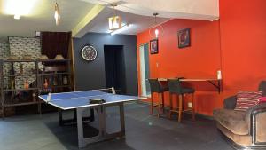 a living room with a ping pong table in it at Miners Rest Lodge in Phalaborwa