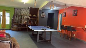 a living room with a ping pong table in it at Miners Rest Lodge in Phalaborwa +5 photos