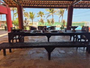 a long table with bowls and plates on it at mansao922 in Aquiraz