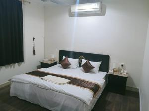 a bedroom with a large bed with white sheets and pillows at Al Eairy Apartment-Alqaseem 4 in Buraydah +51 photos