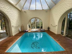 einen Pool in einem Haus mit Glasdecke in der Unterkunft Villa avec Piscine Intérieure, 5 Chambres, Proche Plage et Commerces à Arcachon - FR-1-374-220 in Arcachon