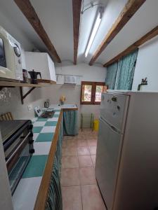 a kitchen with a refrigerator and a counter top at Casa rural El Mestre in Alcudia de Veo +10 photos