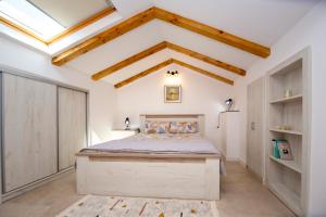 a bedroom with a bed and a vaulted ceiling at Apartment Sara with seaview in Budva