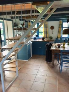 a loft bed in a kitchen with a table at Bauernhaus mit großem Garten in Jordløse +18 photos