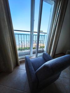 a living room with a couch and a large window at DL Apartments in Aheloy +15 photos