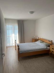 a bedroom with a bed and a large window at Apartmani Lepara in Konjic +28 photos