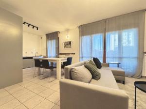 a living room with a couch and a table at Spacious 2-Bedroom Apartment with Large Terrace in Milan