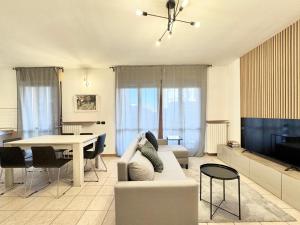 a living room with a couch and a table at Spacious 2-Bedroom Apartment with Large Terrace in Milan